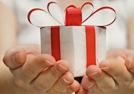Two hands holding out a gift
