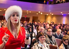 Realtor Cristina Cote in a red dress and furry hat as her alter ego "Svetty."