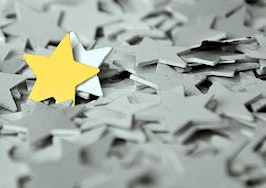 A gold star standing out in a sea of gray stars