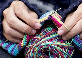 Hands knitting a scarf