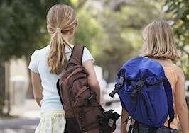 Two girls walking to school.