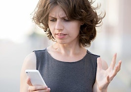 An irritated woman taking a phone call.