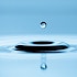 A droplet of water over a water surface