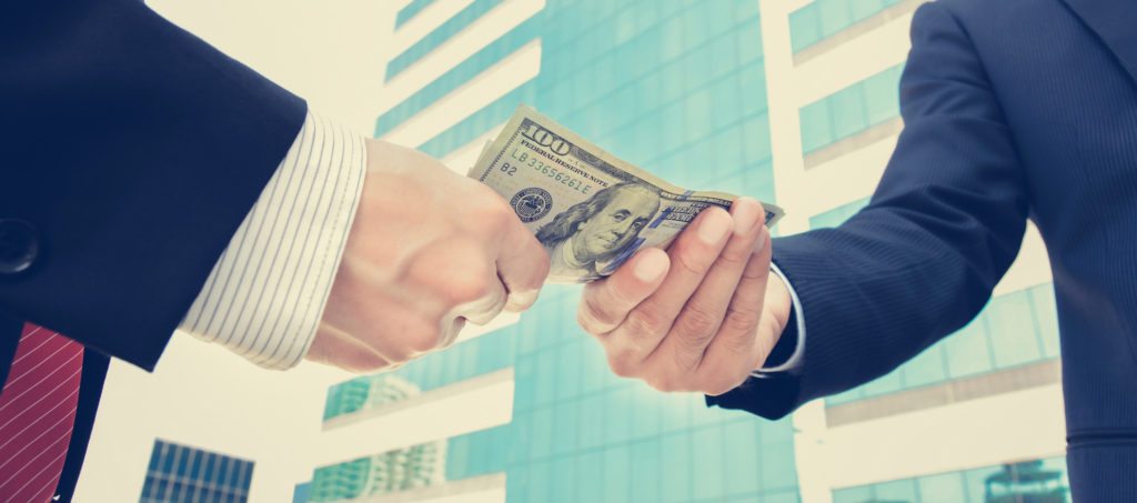 Businessmen exchanging money on the street