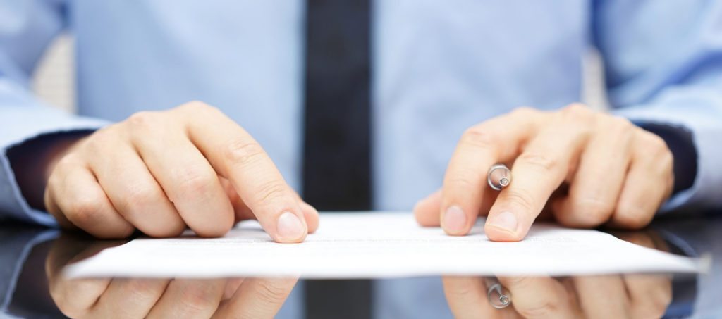 A man examining a contract closely