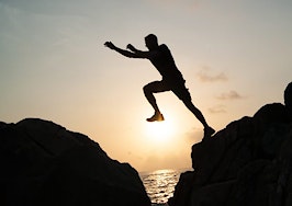 A man jumping across a narrow gap