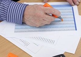 An accountant highlight a spreadsheet
