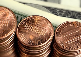 Stacks of pennies near dollar bills