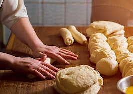 A baker rolling bread made from scratch