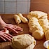 A baker rolling bread made from scratch