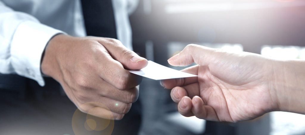 Two men exchanging business cards