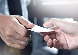 Two men exchanging business cards