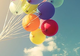 Balloons rising from a child's hand