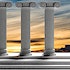 Five pillars against a sunset sky