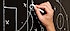 A hand outlining a game plan on a chalkboard