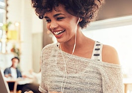 A laughing young woman on her computer
