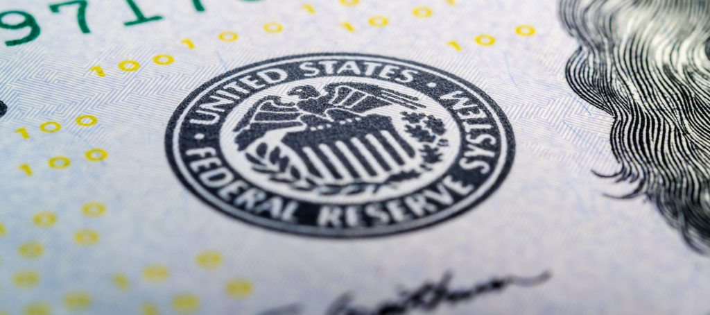 A close-up of the Federal Reserve seal on a $20 bill