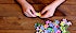A child's hands putting a jigsaw puzzle together