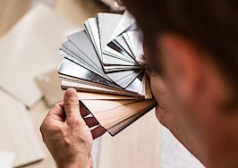 A man looking at samples of paint and flooring