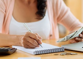 A woman managing a budget at a computer