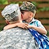 A military father hugging his son