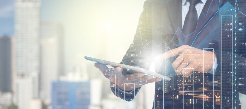 A man checking a tablet with stocks on it