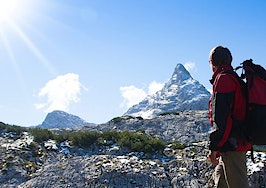 A woman looking ahead at a mountain range