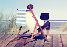 A businessman working by the beach