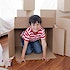A child playing in moving boxes