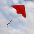 A red kite flying in the sky