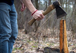 A man splitting a log