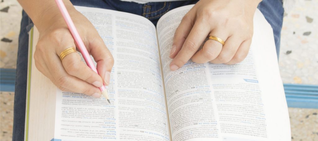 A woman researching in a dictionary
