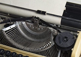 A typewriter with a sheet of paper