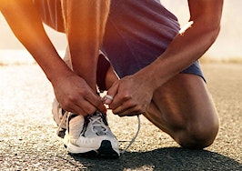 A man lacing up his shoes for a run