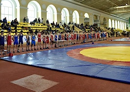A group of wrestlers at a mat