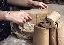 A pair of hands shaping clay