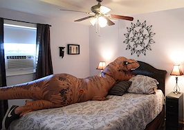 A giant T. rex costume is helping this real estate agent sell a home