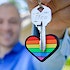 Man holding a rainbow keychain