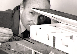 man looking at model of house