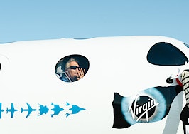 Richard Branson waves from the window of the VSS Unity22 on July 11, 2021 before its spaceflight.